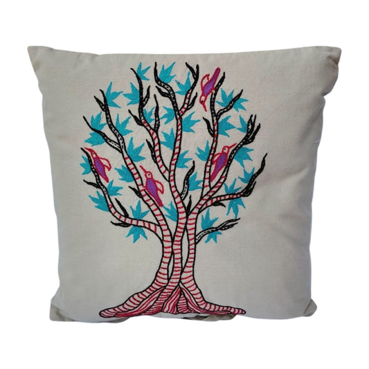 Decorative pillow with a tree and birds design on a light grey  background.
