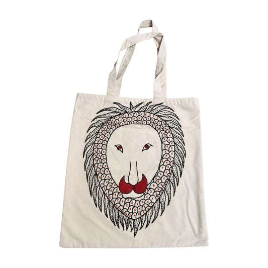 Tote bag with a lion's face design on a off white background inspred from Gond Art.