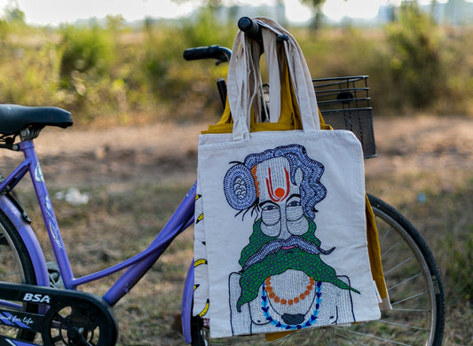 Hand embroidered tote bag with the image of a monk. Handmade by women artisans.